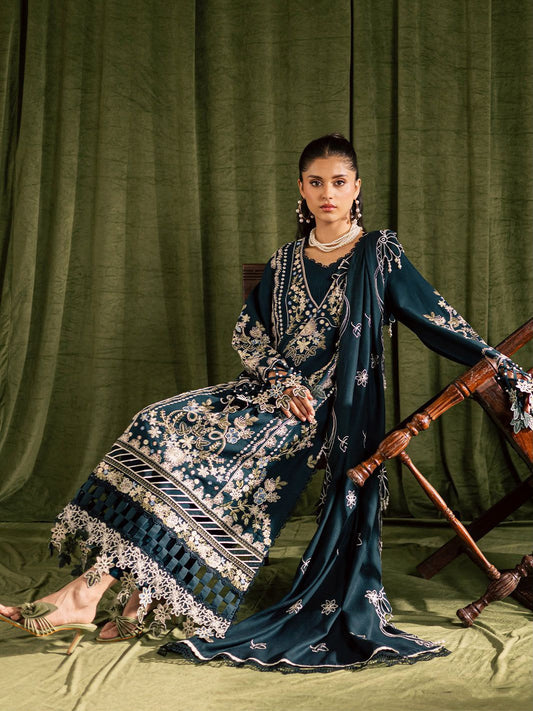 Woman in a dark blue embroidered traditional outfit against a green curtain background