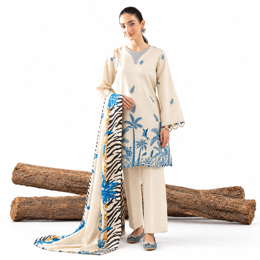 Woman wearing a beige outfit with floral patterns, standing against a white background with wooden logs.