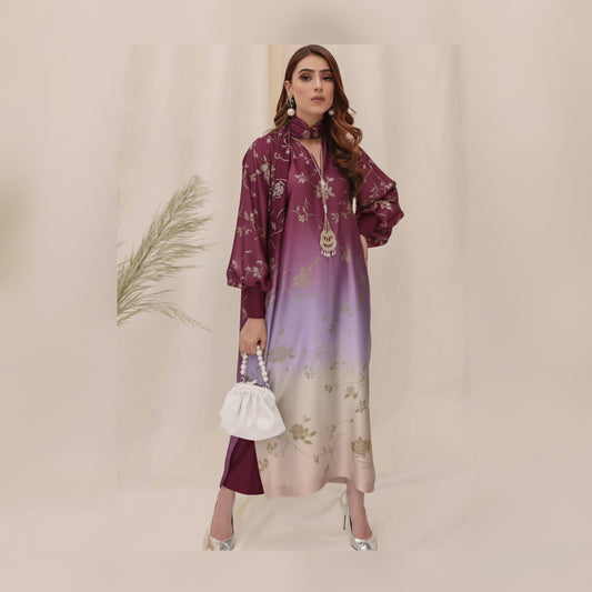 Woman wearing a gradient dress with floral patterns against a neutral background