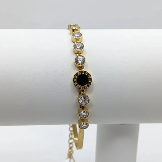 Gold bracelet with gemstones on a white background