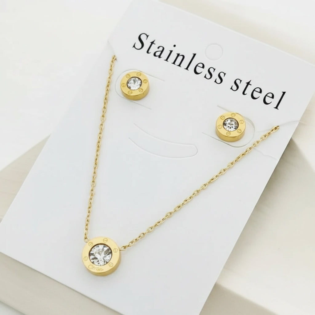 Gold-tone stainless steel necklace and matching stud earrings displayed on a white card labeled 'Stainless steel'.