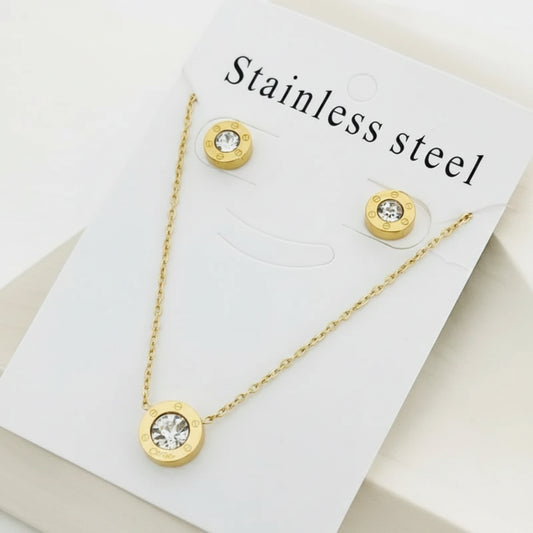 Gold-tone stainless steel necklace and matching stud earrings displayed on a white card labeled 'Stainless steel'.
