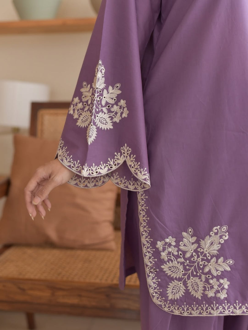 Purple garment with white embroidery on a blurred indoor background