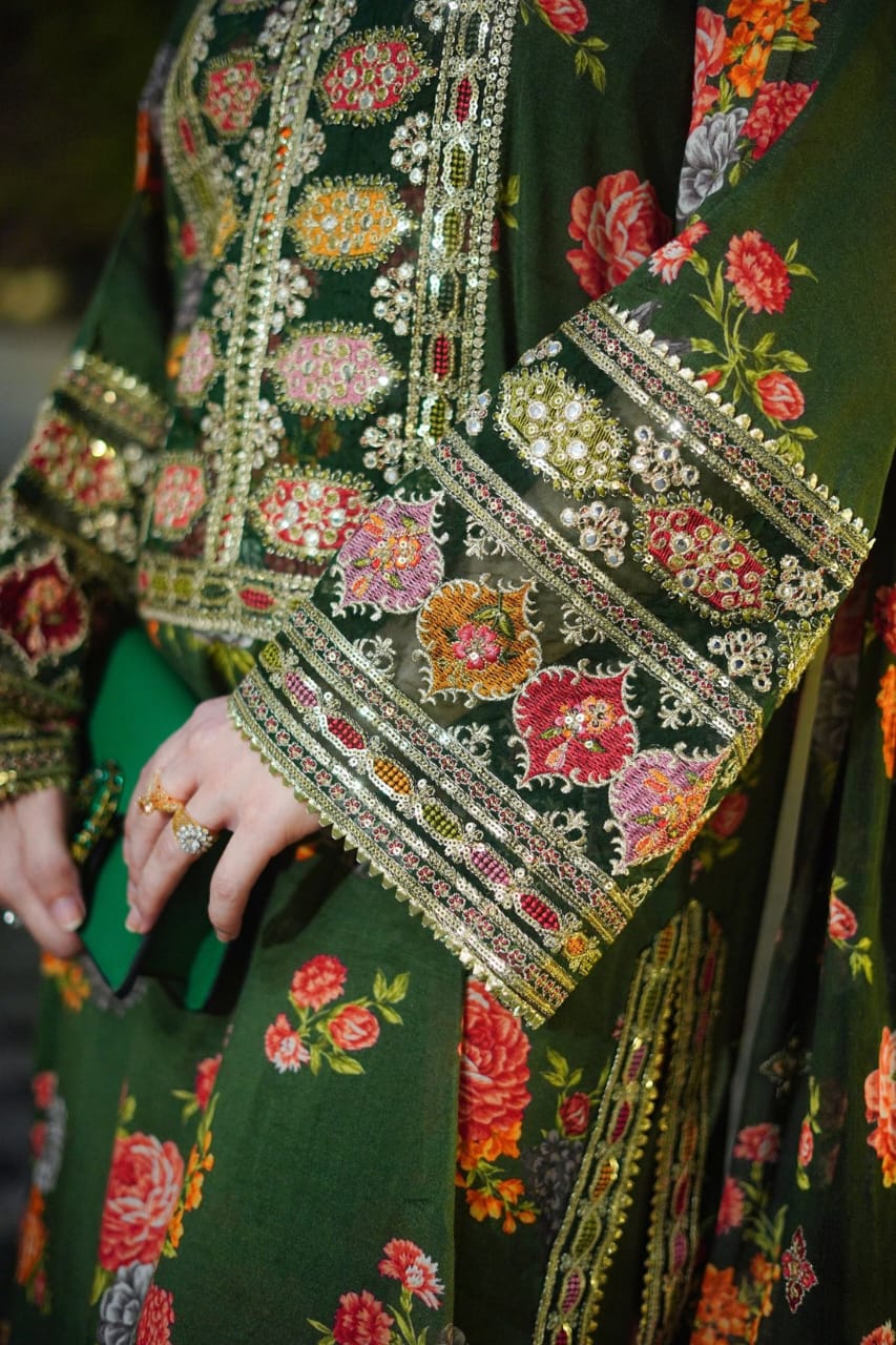 Close-up of a green embroidered garment with floral patterns