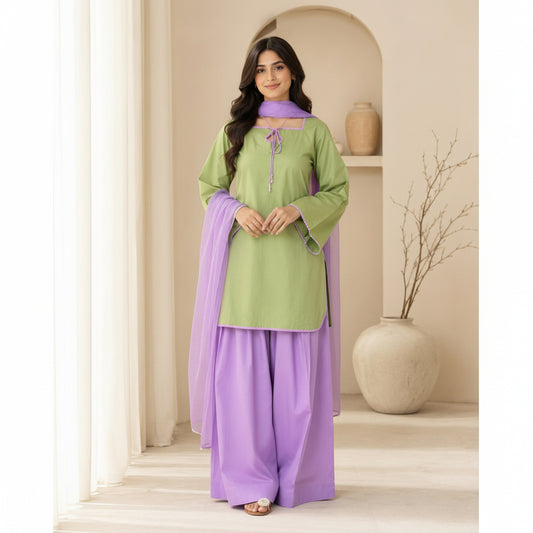 A woman modeling a traditional Indian outfit consisting of a light green kurta with a purple collar and tie detail, paired with wide-leg purple palazzo pants, in a neutral indoor setting.