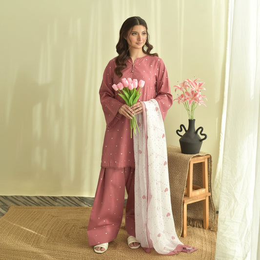 Woman in traditional outfit holding flowers indoors with a neutral background
