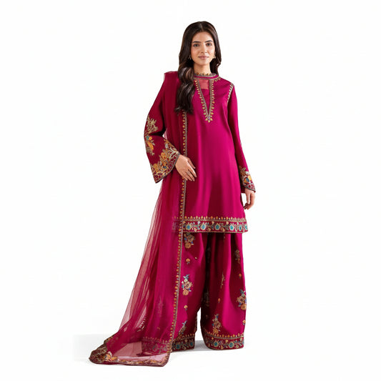 Woman wearing a pink traditional outfit with intricate designs on a beige background