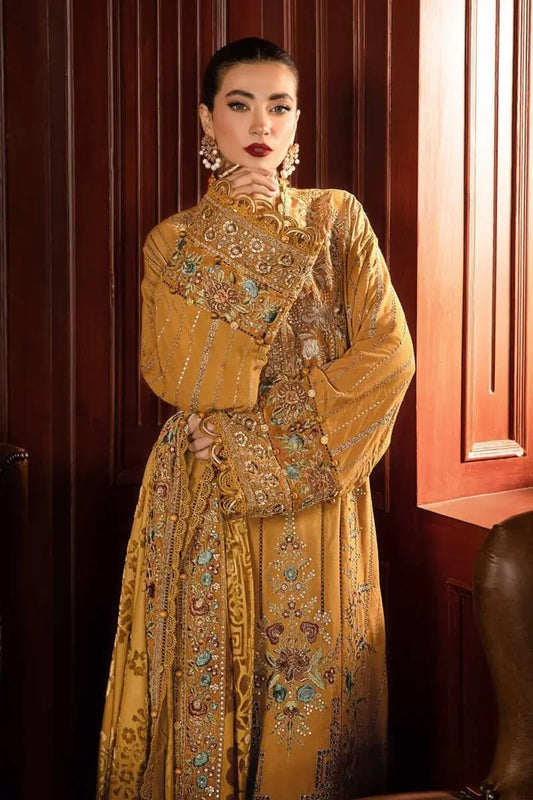 Woman wearing a yellow embroidered traditional outfit in a room with wooden paneling.