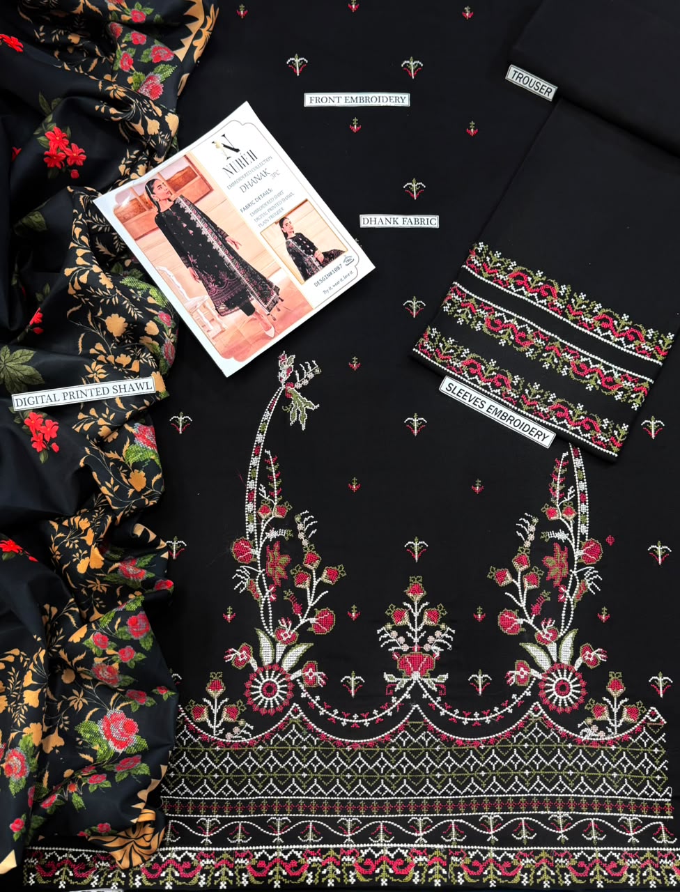 Black unstitched salwar suit material set featuring floral printed dupatta, embroidered kurta fabric with pink and red floral patterns, and matching embroidered trouser fabric, arranged as a flat lay with a brand card.