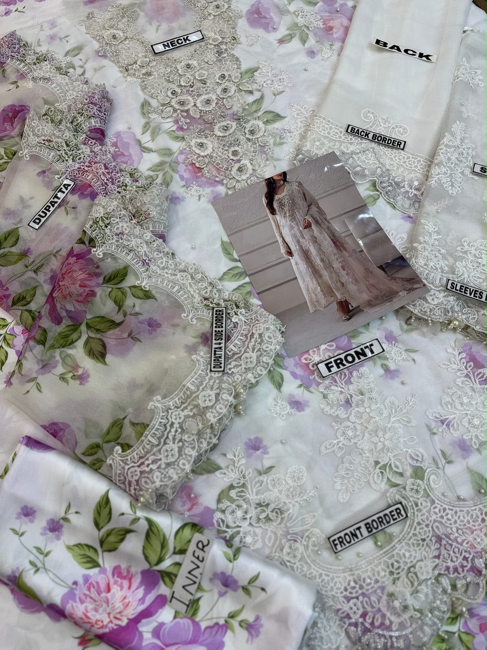 Maria B off-white floral embroidered chiffon shirt with Adda handwork and digital printed silk trouser.   