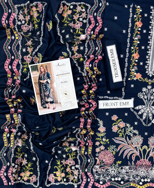 A navy blue fabric garment or textile laid flat, decorated with dense floral embroidery in pink, white, yellow, and green. A printed paper insert and two white fabric labels reading 'TROUSER FAB' and 'FRONT EMP' are placed on top of the fabric.