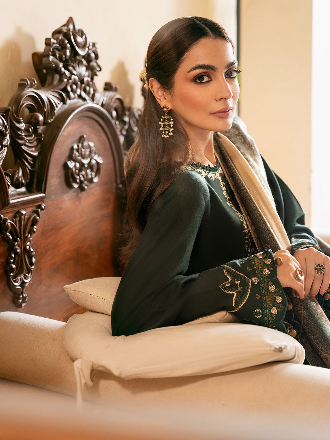Woman in traditional attire sitting on an ornate chair