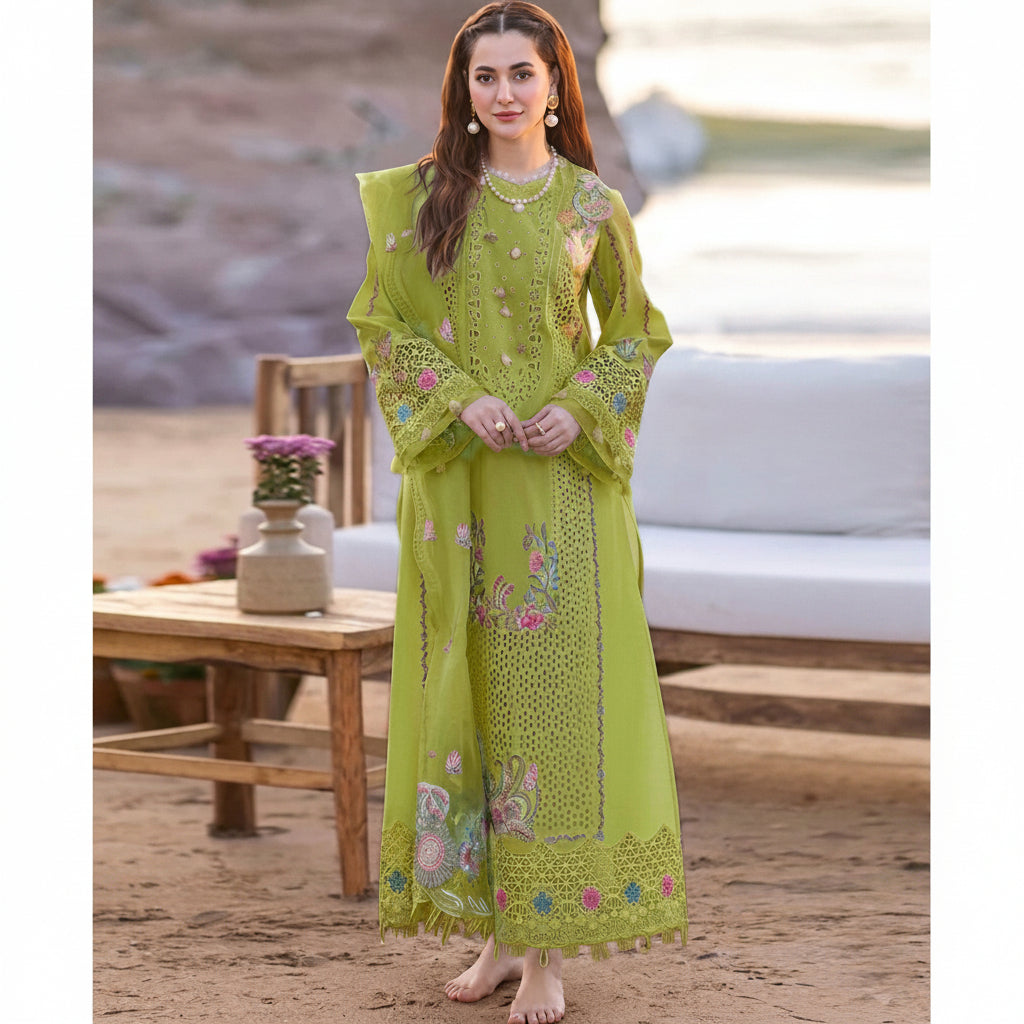 Woman wearing a green embroidered outfit with 'Jazmin' branding and product details.