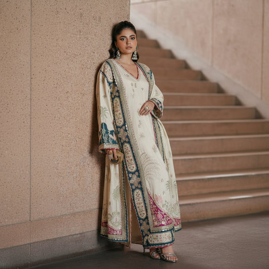 Woman in a traditional outfit standing on a staircase with a neutral wall background