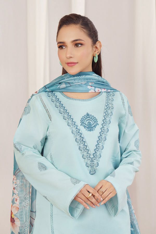Woman wearing a light blue embroidered traditional outfit with a matching dupatta.