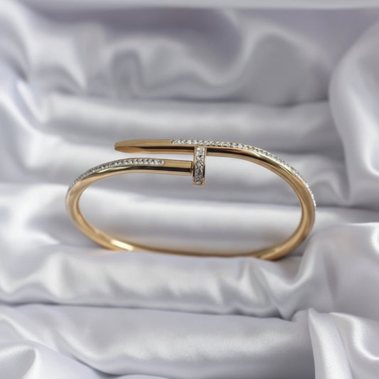 Gold bracelet with diamonds on a white satin background